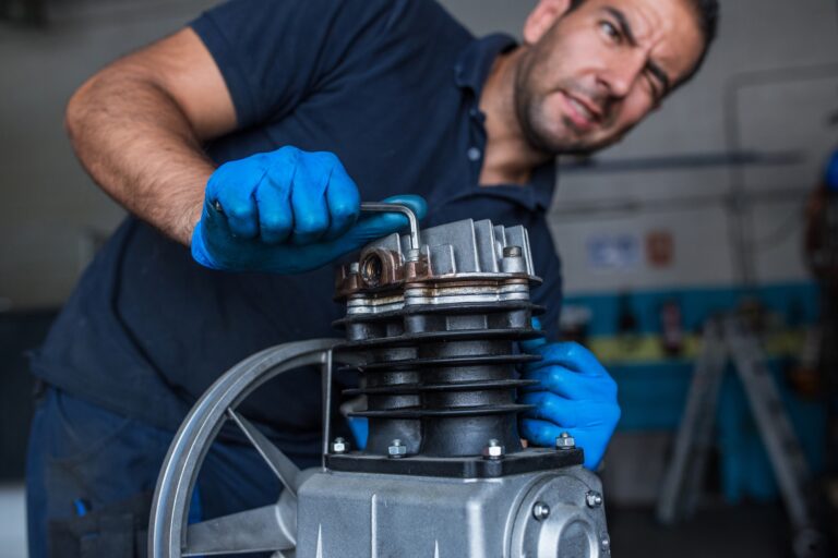 Mechanic fixing a compressor engine
